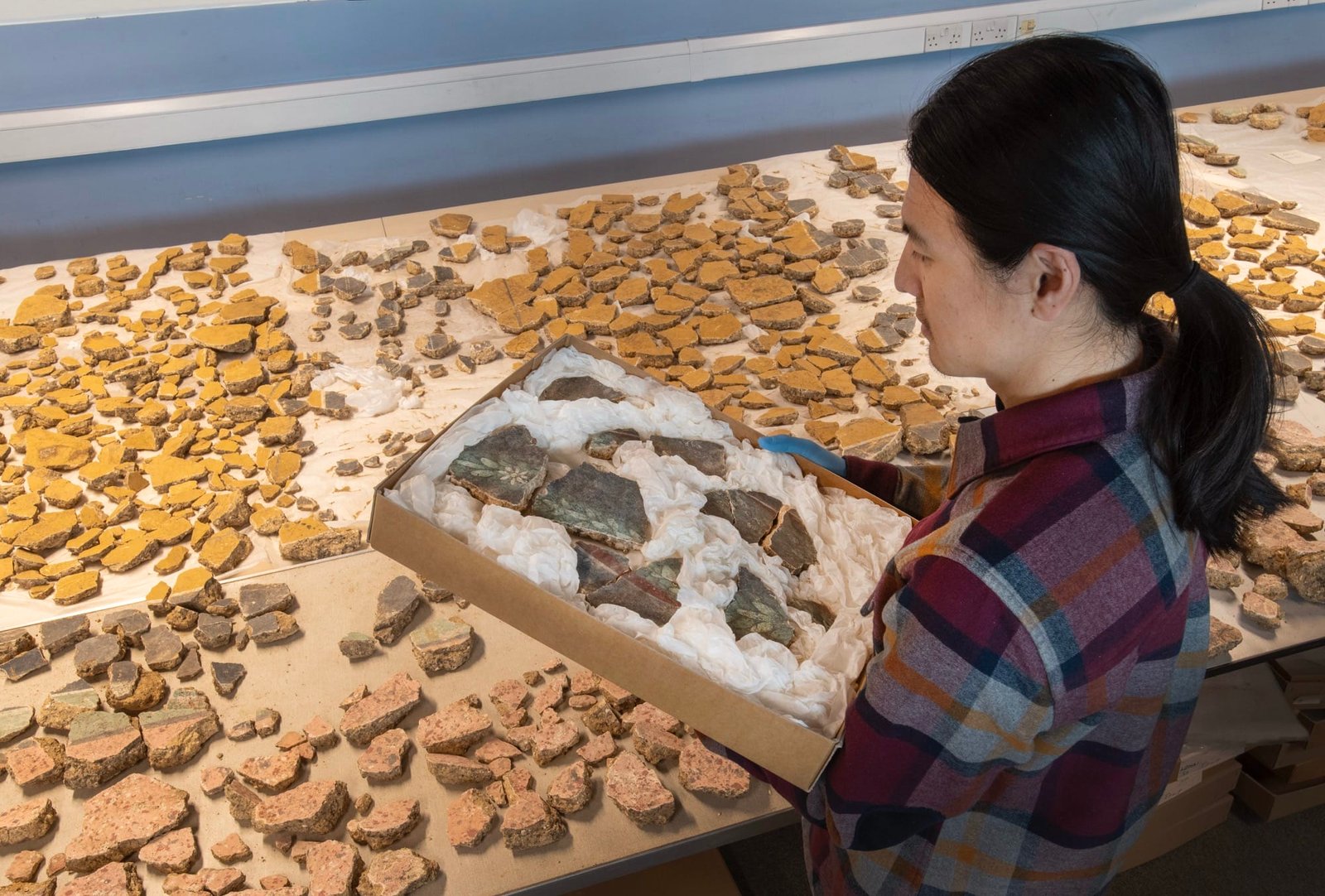 a researcher works on arranging fragments of a Roman fresco