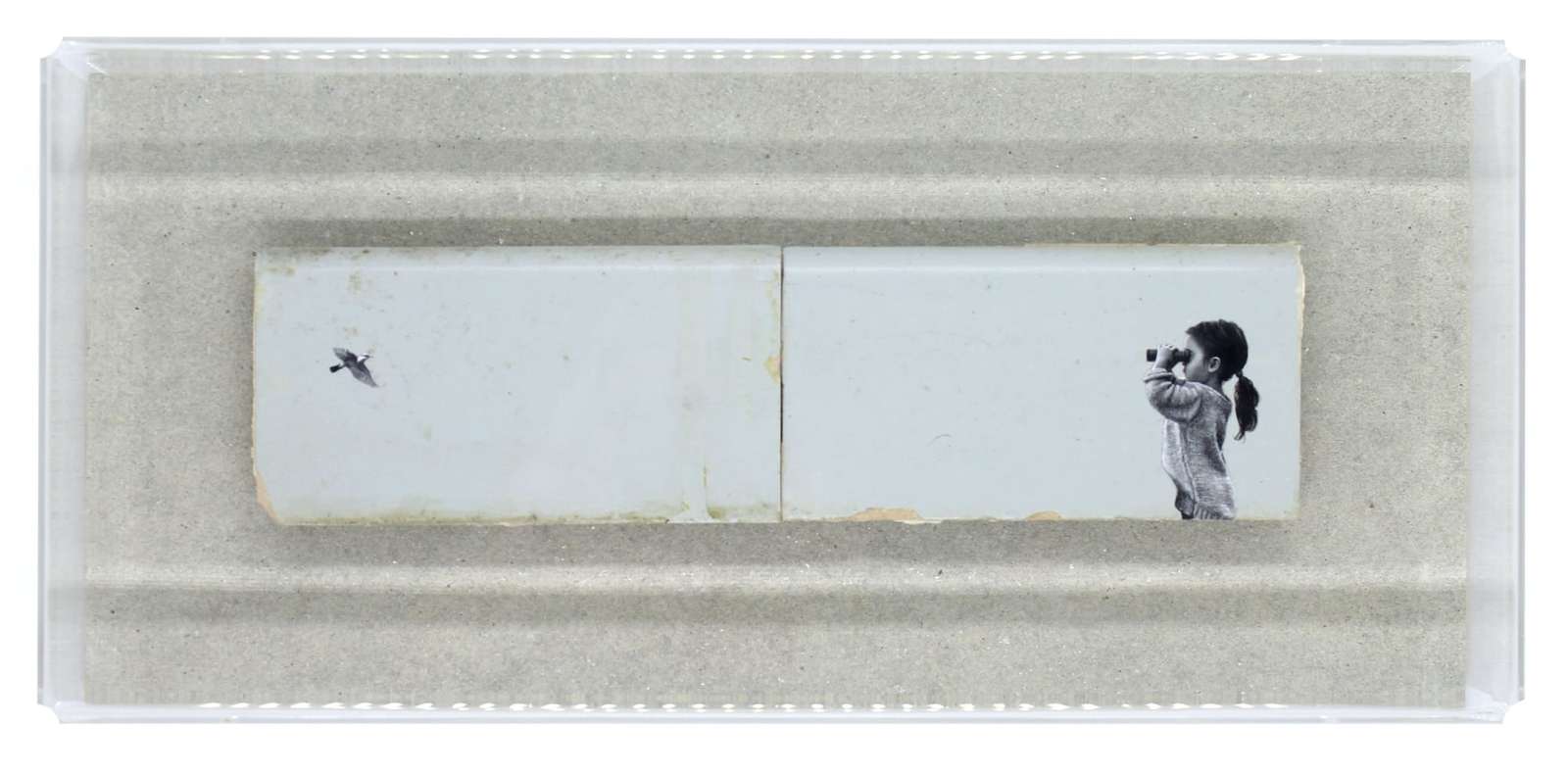 a child looks out across two bricks at a bird flying to the left