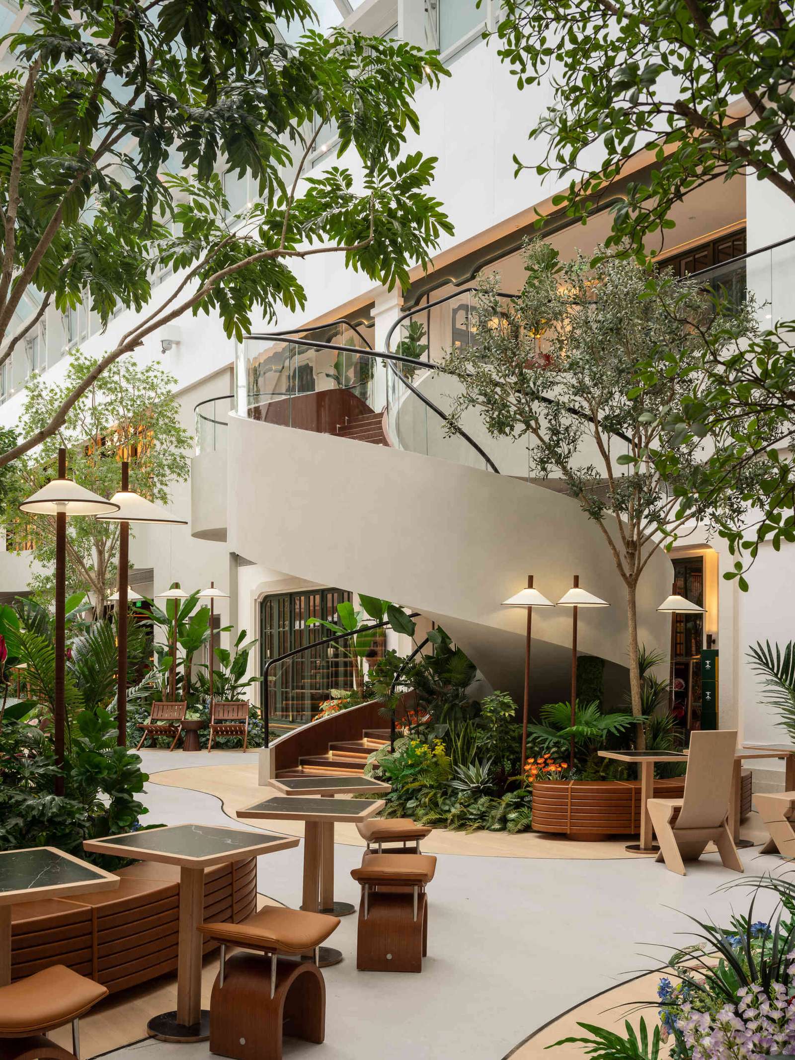  A vine-like spiral staircase rises gracefully through the atrium, serving as both a sculptural element and a gentle transition between floors. Light, fluid, and rooted in the garden aesthetic.Under-stair lighting adds a gentle glow to each tread, guiding movement without disrupting the calm atmosphere. Subtle, functional, and beautifully integrated into the space.