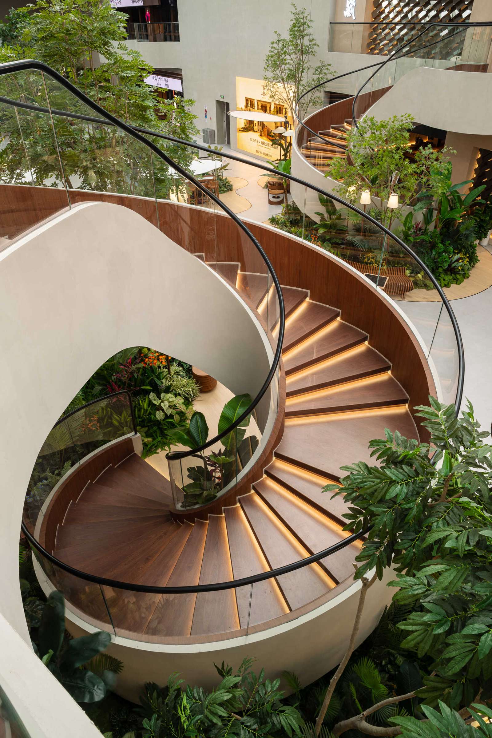 A pair of vine-like spiral staircase rises gracefully through the atrium, serving as both a sculptural element and a gentle transition between floors. Light, fluid, and rooted in the garden aesthetic.Under-stair lighting adds a gentle glow to each tread, guiding movement without disrupting the calm atmosphere. Subtle, functional, and beautifully integrated into the space.