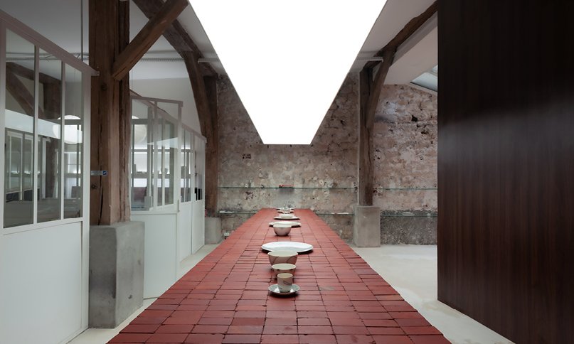 red bricks line the refreshment club's kiln-inspired flagship for parisian porcelain house 