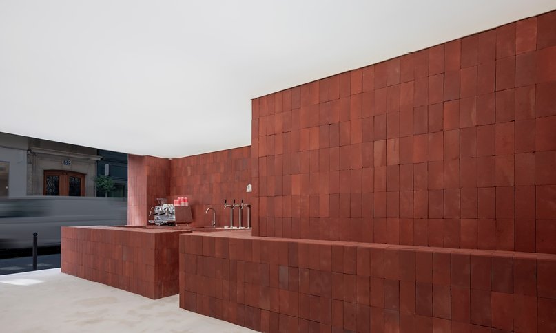red bricks line the refreshment club's kiln-inspired flagship for parisian porcelain house 