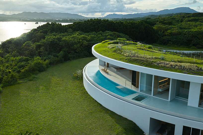 sou fujimoto's circular green-roofed villa for NOT A HOTEL opens on ishigaki island, japan