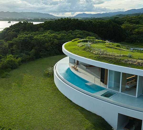 sou fujimoto's circular green-roofed villa for NOT A HOTEL opens on ishigaki island, japan