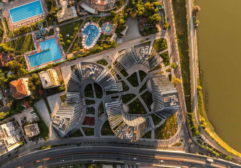 JA joubert architecture sculpts undulating lakefront district following sloped terrain in tirana