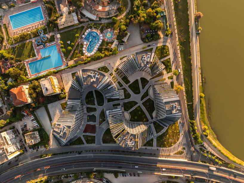 JA joubert architecture sculpts undulating lakefront district following sloped terrain in tirana