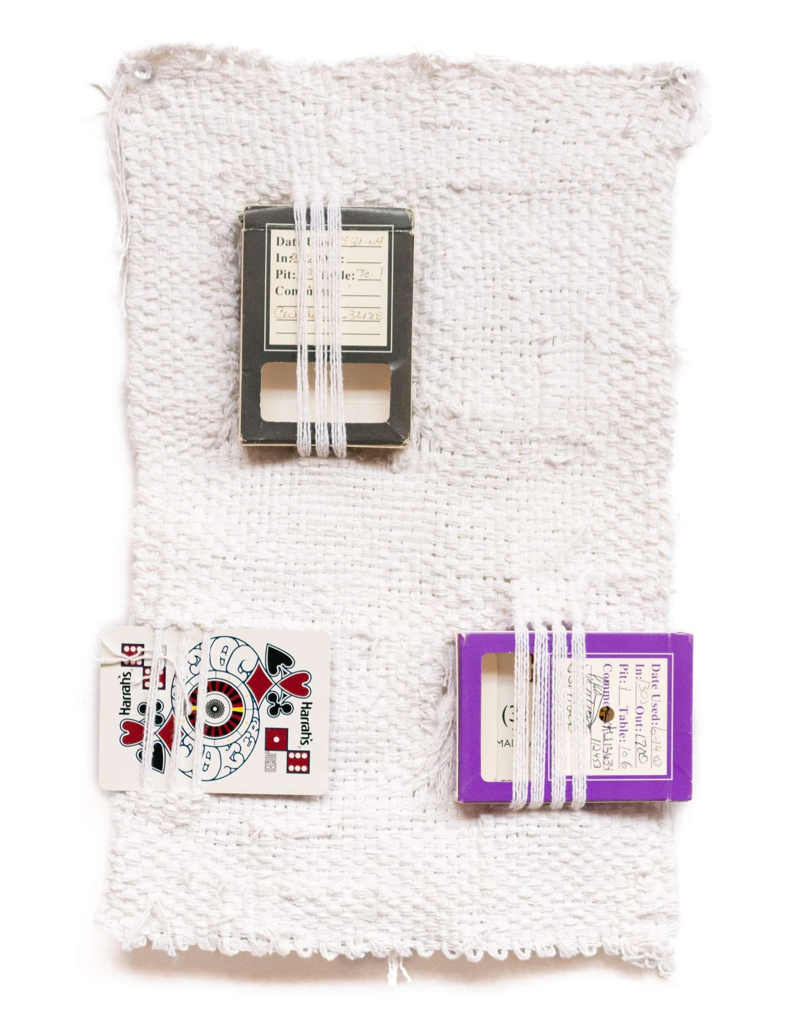 a weaving with two boxes and a playing card