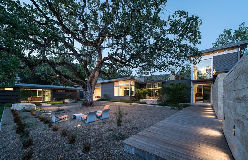 A central courtyard shaded by a heritage Valley Oak, with meandering paths designed to connect every part of the home to nature.