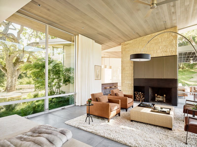 Warm cedar ceilings, sleek oil-rubbed steel, and cool concrete floors create a modern yet inviting interior style.