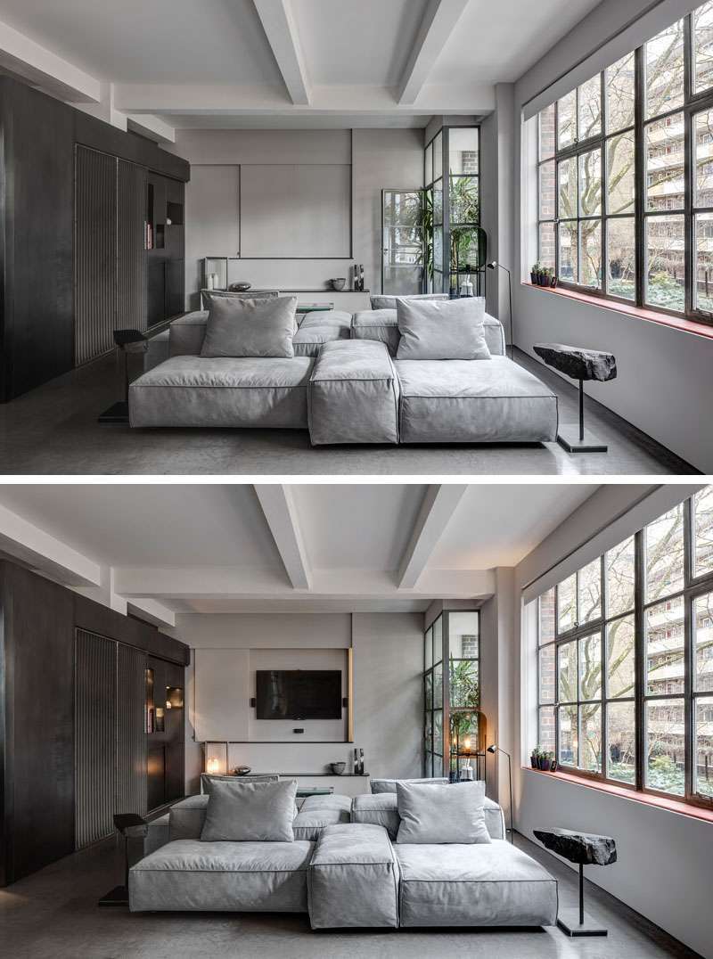 In the living room, a key design element is the double-sided couch. One faces a hidden television, while the other looks toward the kitchen and dining space, reinforcing the apartment’s sense of choreographed movement. 