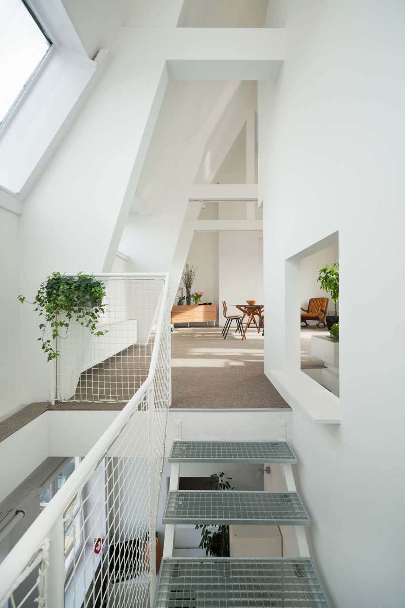 Bright white walls reflect every bit of natural light in this renovated Amsterdam duplex, creating a fresh, open atmosphere even on the gloomiest days.