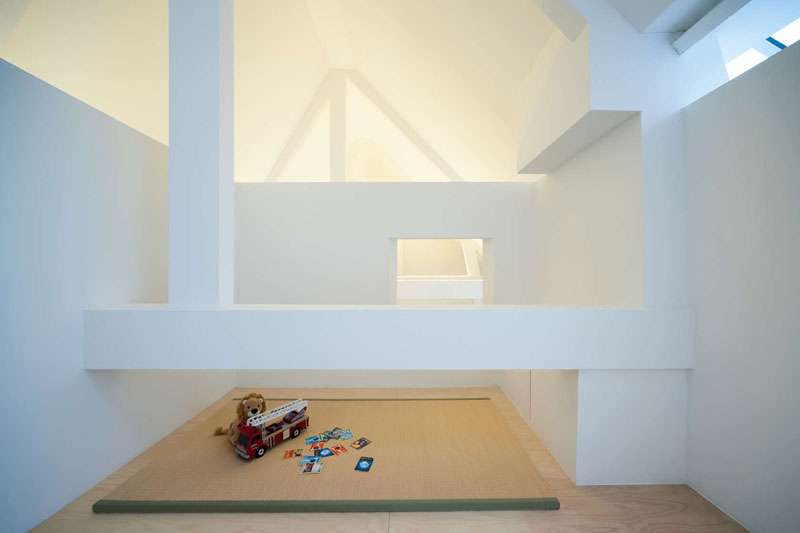 Lofted above the kitchen, this cozy play space makes creative use of vertical volume while keeping kids connected to the heart of the home.