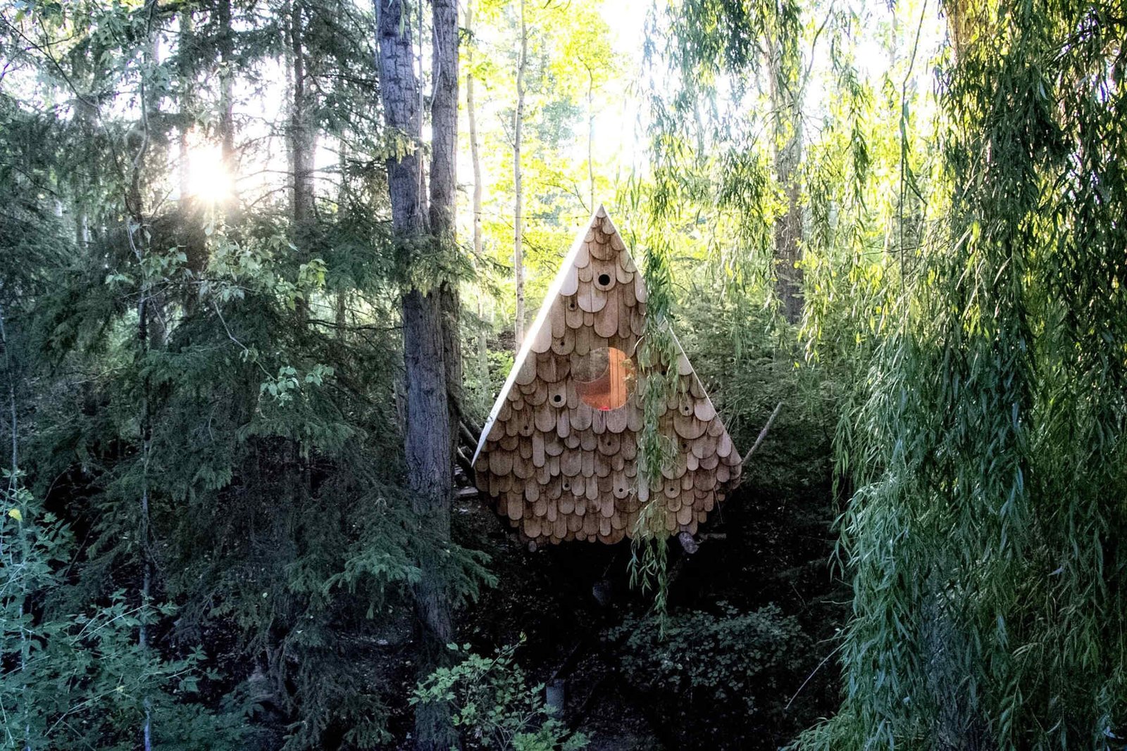 A tiny treehouse in the forests of Canada that’s also home to local birds. Designed by Studio North, the Birdhut blends into the canopy with its whimsical design, reclaimed materials, and built-in birdhouses that let humans and wildlife share the same space.