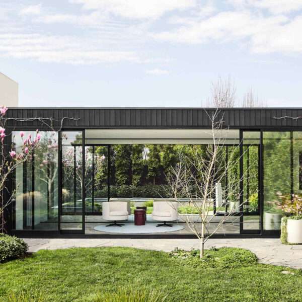 This Melbourne residence combines a restored Victorian facade with dark timber and glass for a seamless modern contrast.