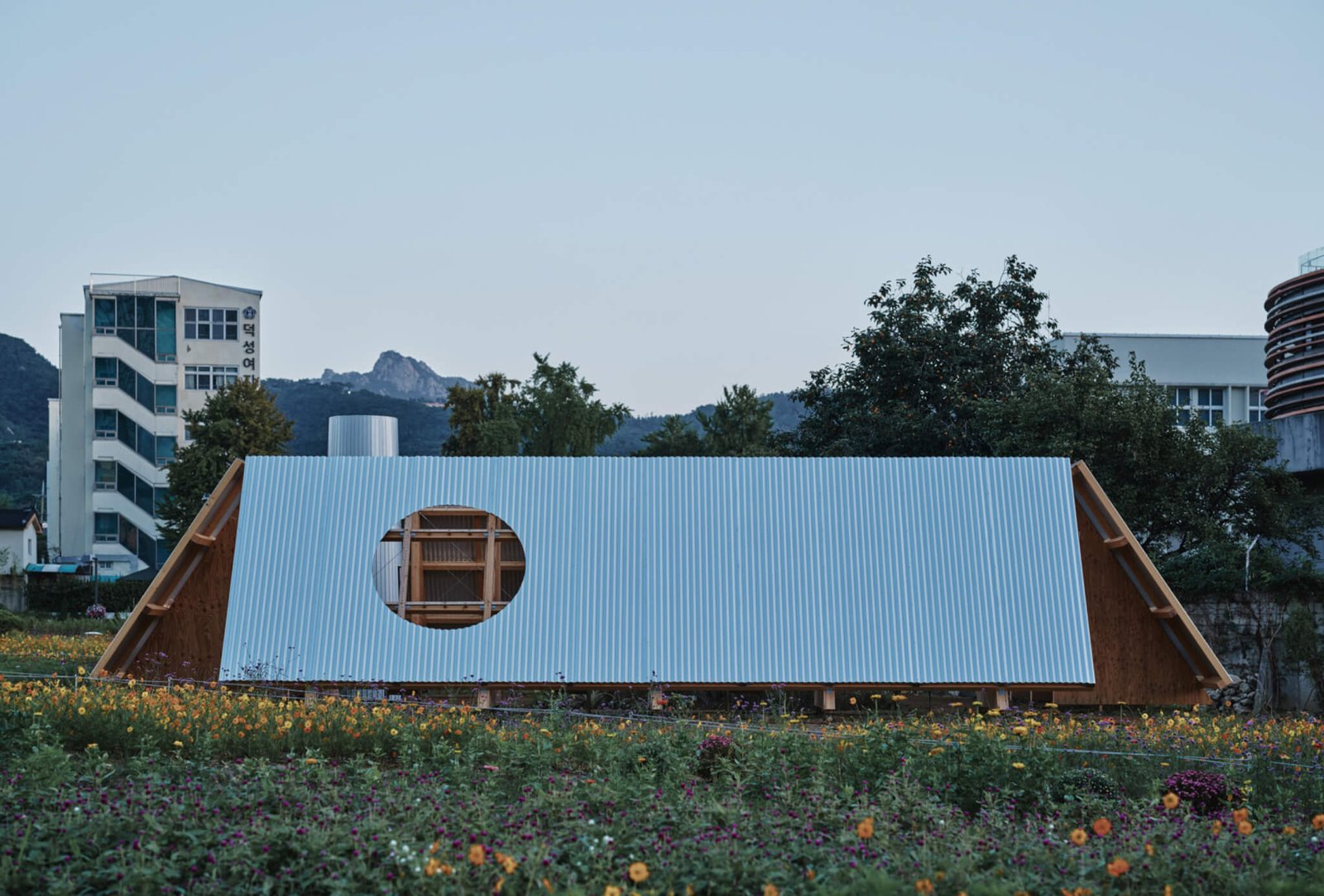 pavilion with slanted walls in a field