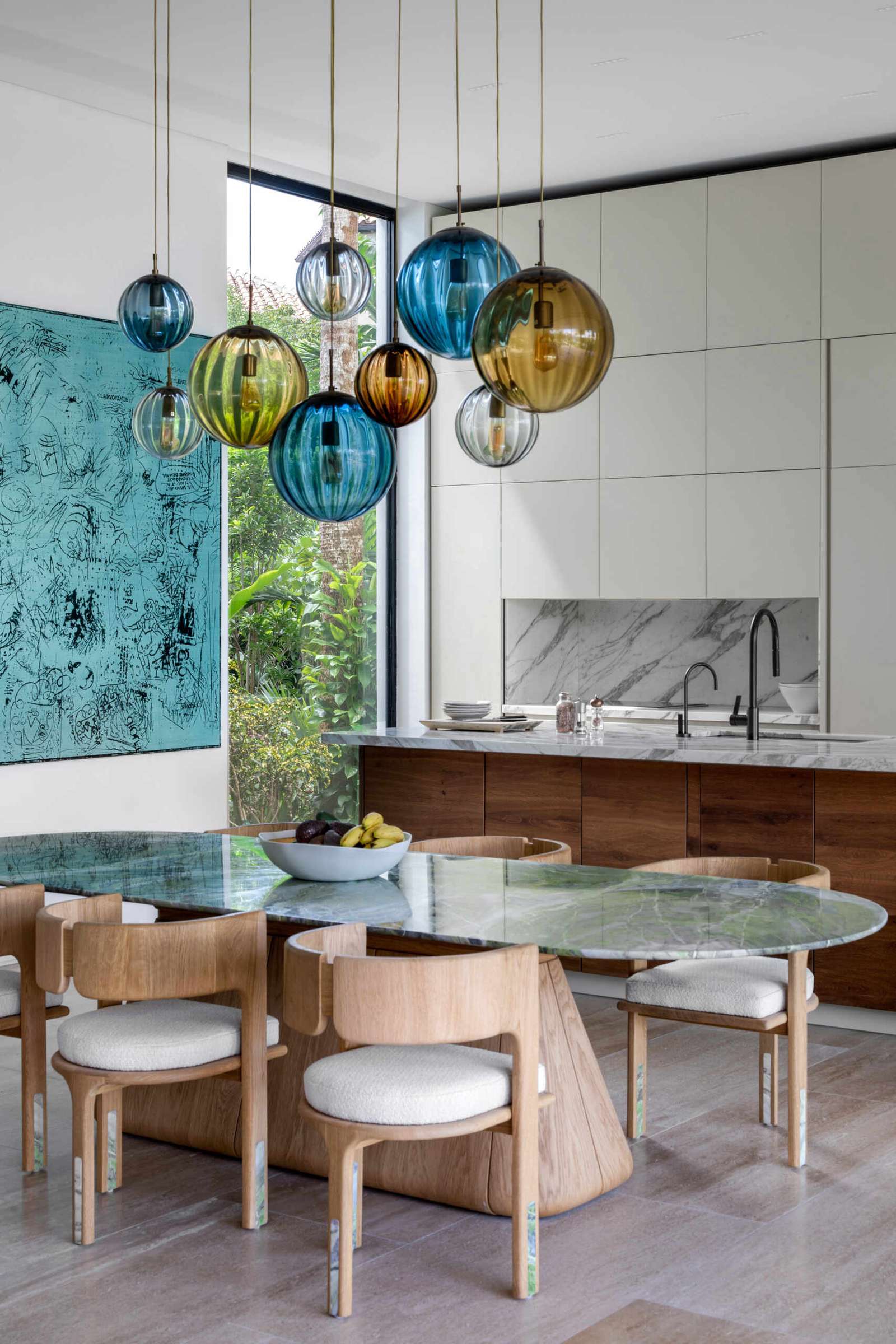 Interiors filled with timber, stone, and local artwork create a warm contrast to the clean architecture.