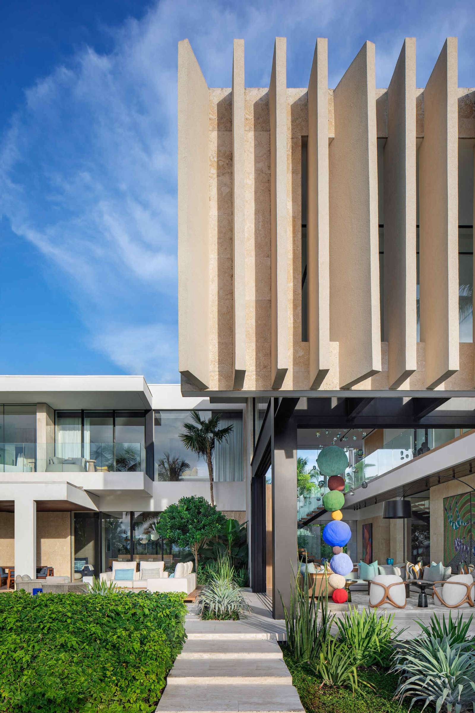 A tropical home with outdoor rooms and an infinity pool that blends naturally with the canal and surrounding greenery.