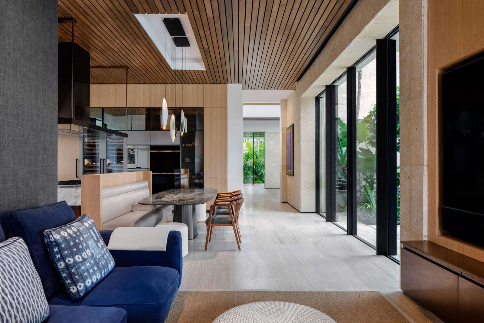 Interiors filled with timber, stone, and local artwork create a warm contrast to the clean architecture.