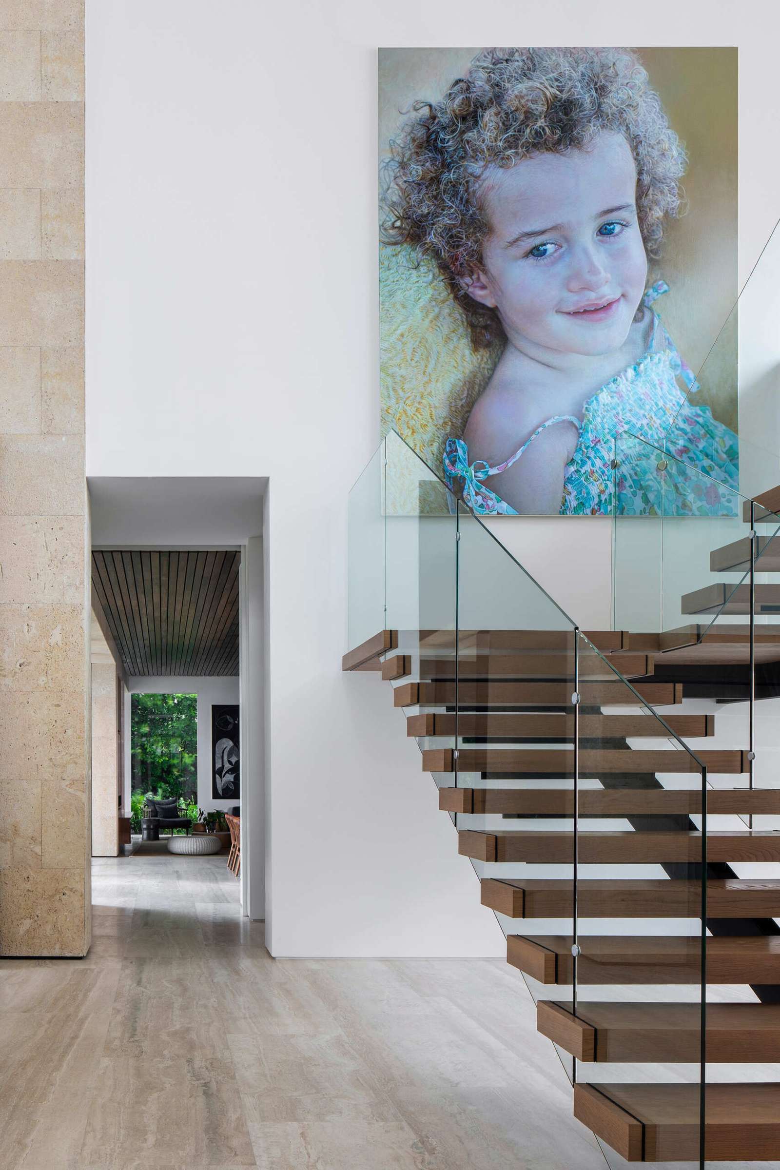 Interiors filled with timber, stone, and local artwork create a warm contrast to the clean architecture.