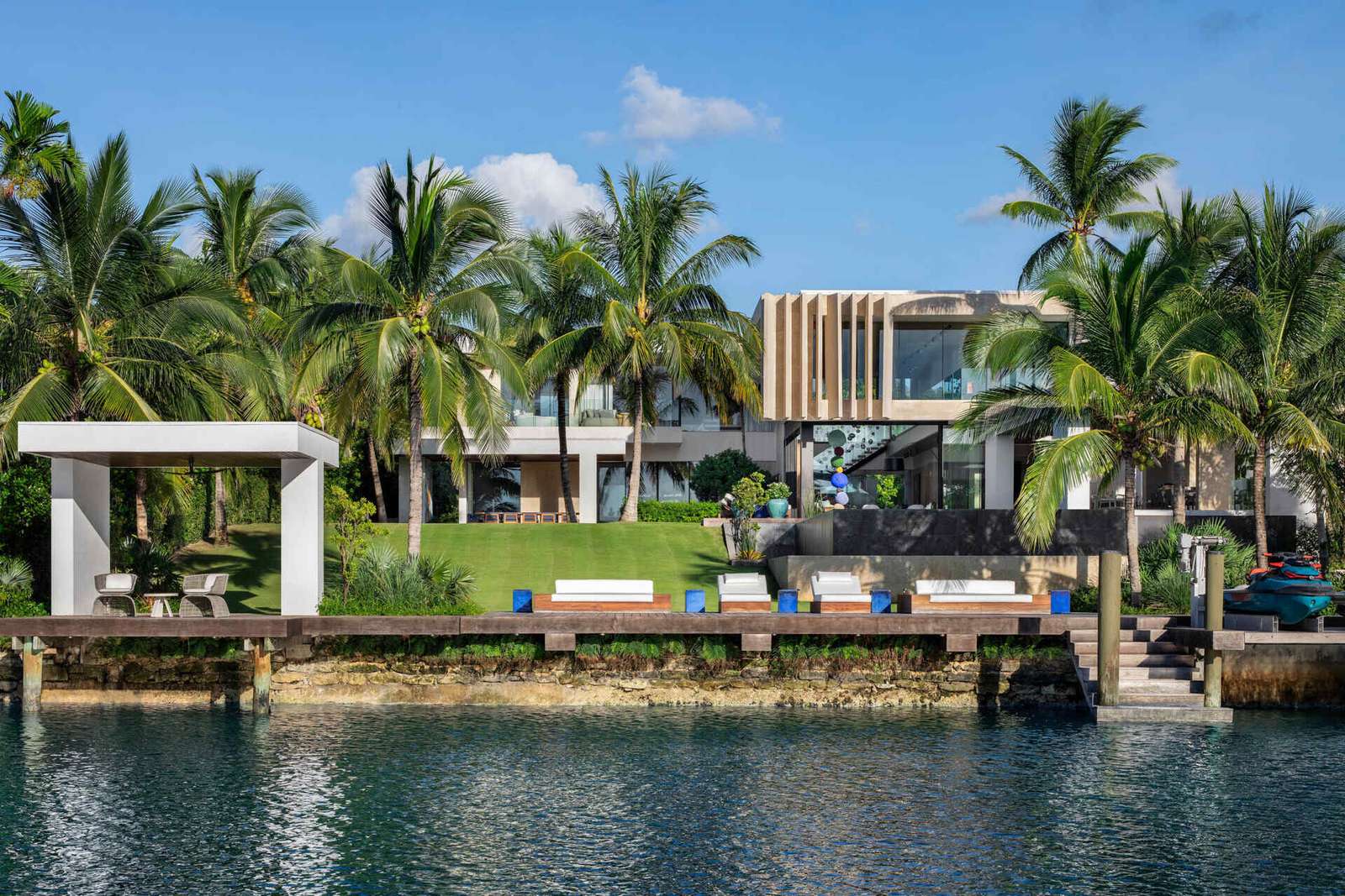 A calm Bahamian villa where coral stone, tropical gardens, and canal side views shape every room.