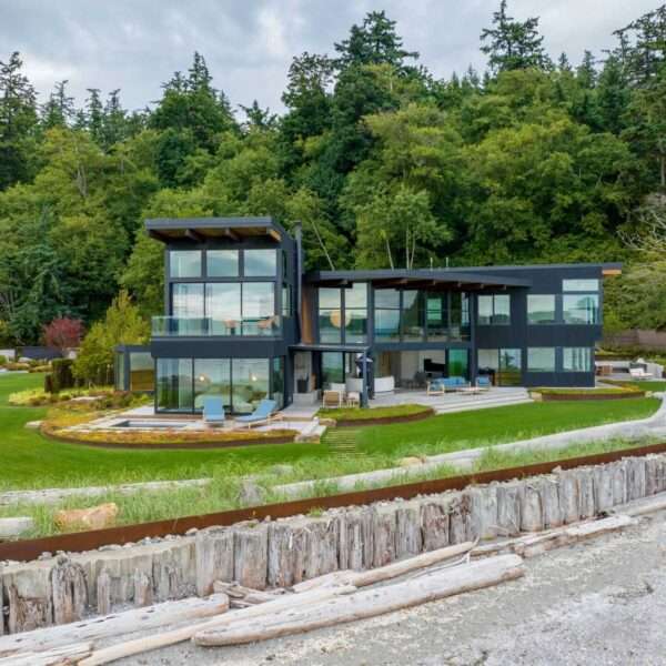 This coastal home shows how architecture can respond directly to land, regulation, and risk. Designed within an existing footprint, the form reflects shoreline rules, steep slopes, and long term durability in a marine environment.