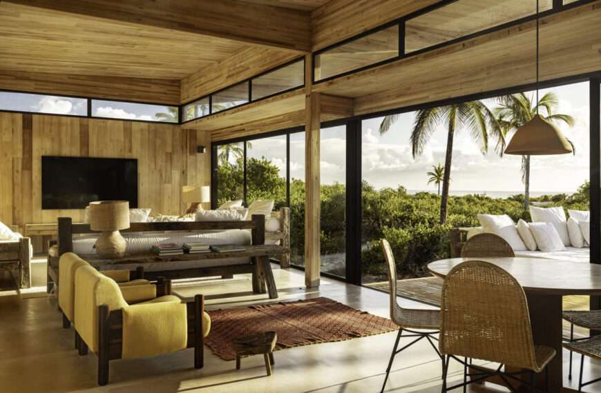 A modular home set between the river and the sea, designed for calm tropical living. Warm wood interiors, large glass openings, and open patios create a seamless flow between forest, coast, and indoor comfort.