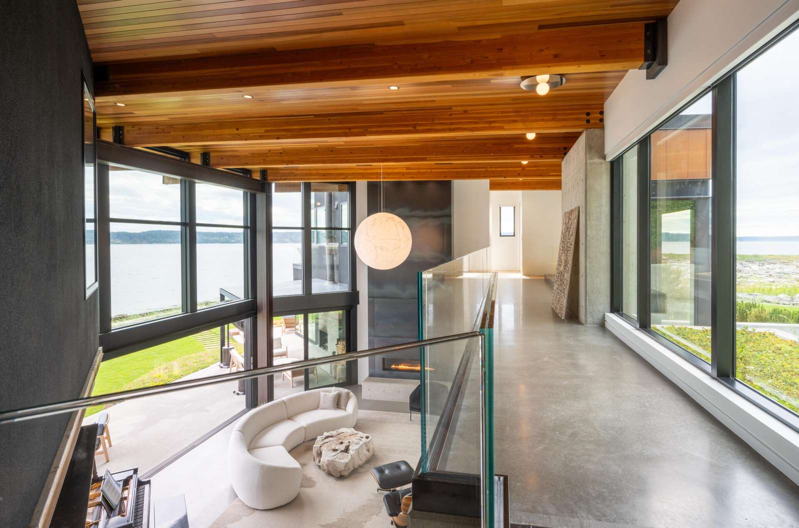 An interior bridge connects the north and south wings of this home. From this vantage point, the green roof above the entry becomes a prominent visual element. The bridge reinforces the sense of movement and connection throughout the home.