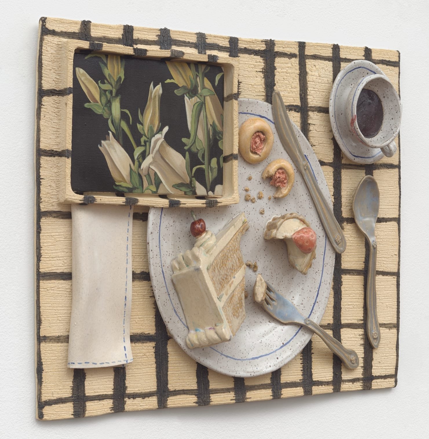 a ceramic sculpture by Stephanie Temma Heir featuring a plate of half eaten cake on a placemat with a cup of coffee and painting of flowers 