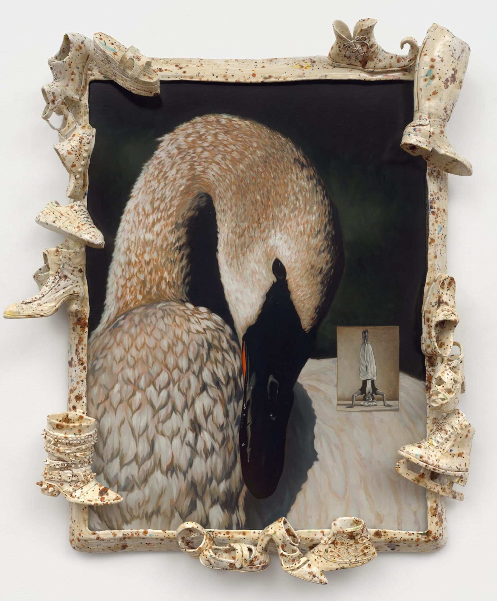 a ceramic sculpture by Stephanie Temma Heir featuring a painting of a swan embedded with a smaller painting of a figure doing a handstand. the frame features speckled footwear