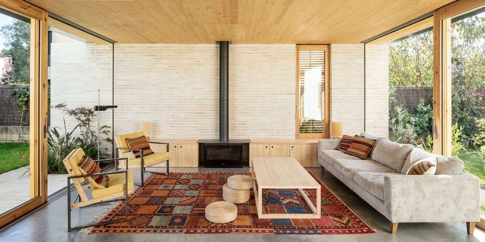 The living space features a fireplace with built-in storage, grounding the open plan while keeping the layout practical and uncluttered.