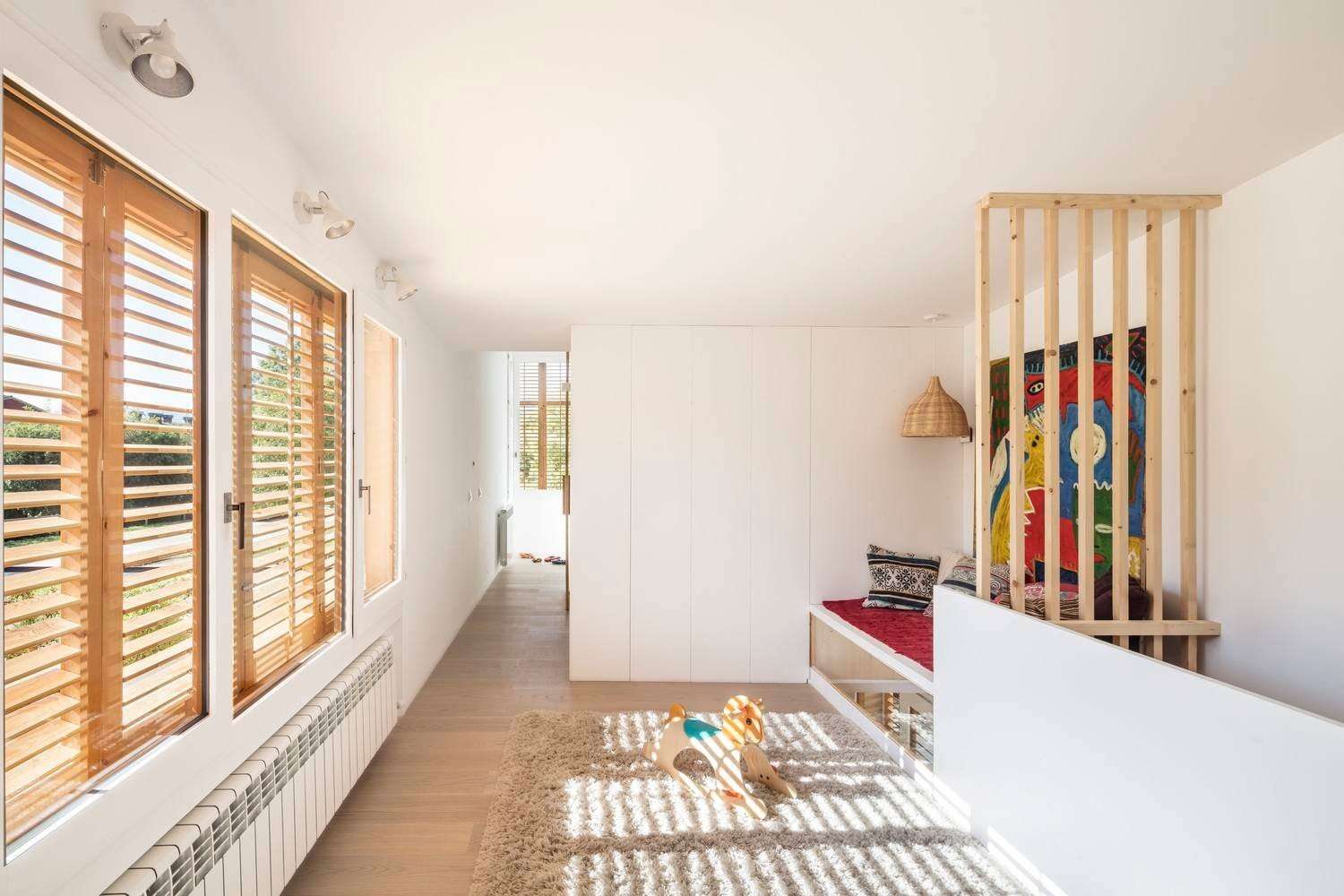 An open play area with a day-bed adds flexibility upstairs, adapting easily to rest, play, or downtime.