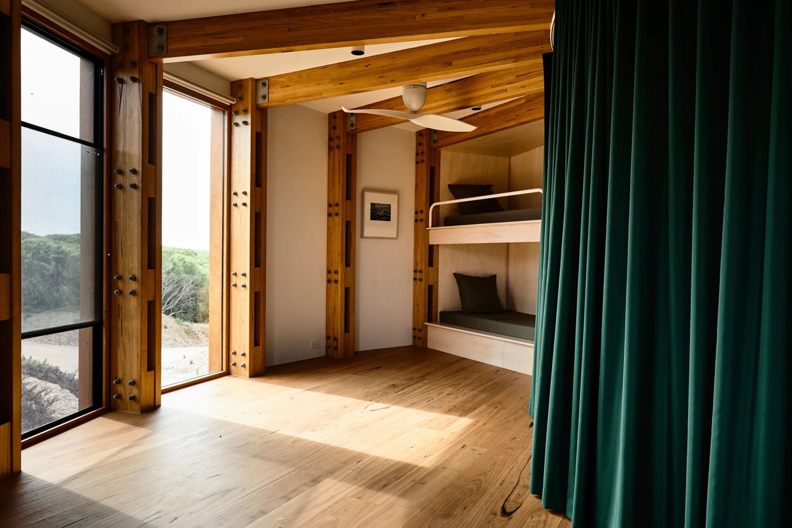 A flexible bunk room with curtain dividers inside a compact circular holiday home.
