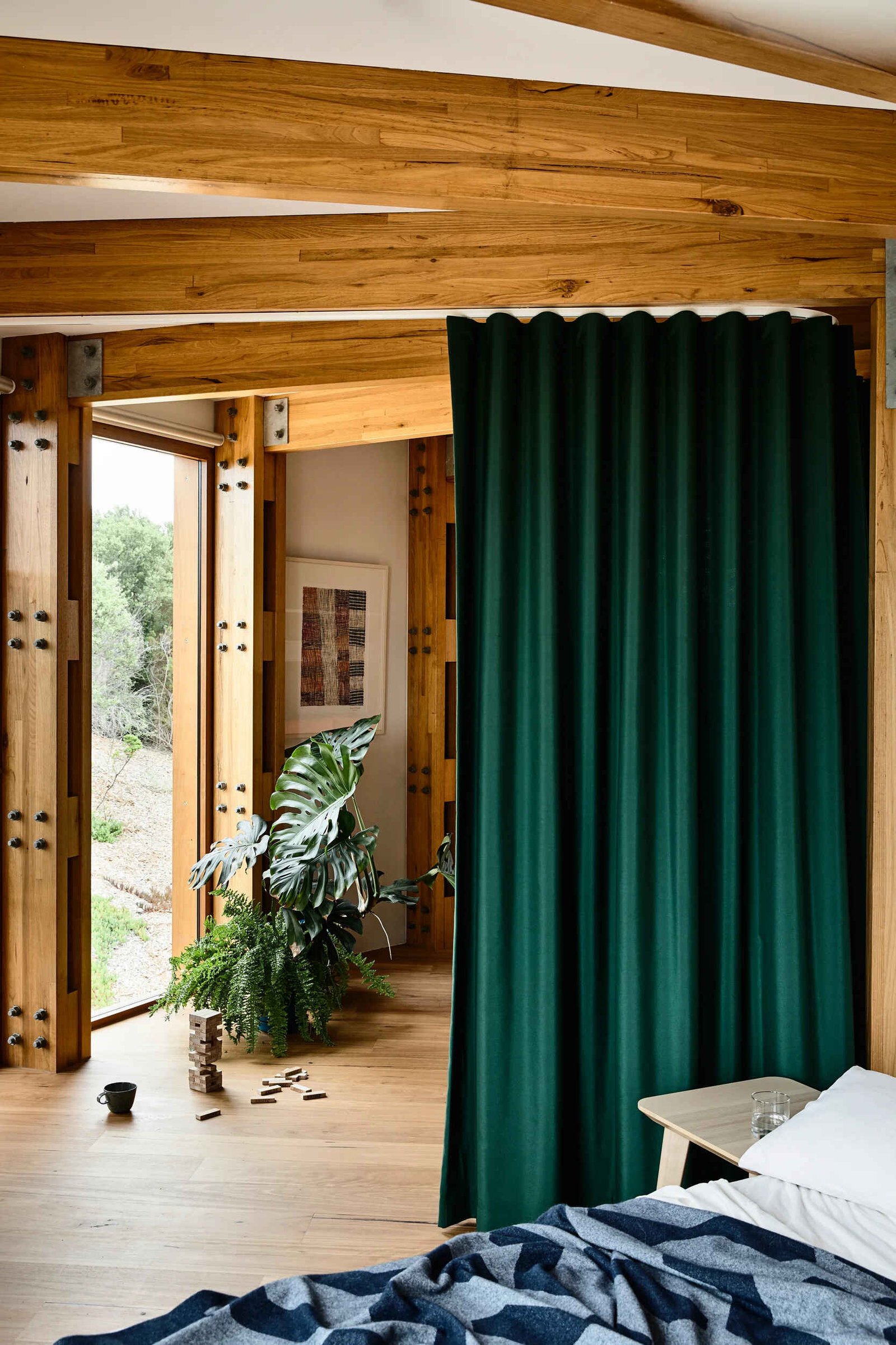 A flexible bunk room with curtain dividers inside a compact circular holiday home.