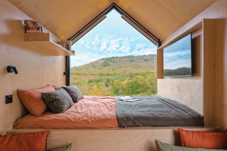 Set on a rolling hillside just outside Budapest, this compact cabin is designed to frame the landscape, not compete with it. With a minimal footprint and partially prefabricated structure, it sits lightly on the terrain while maximizing every view.