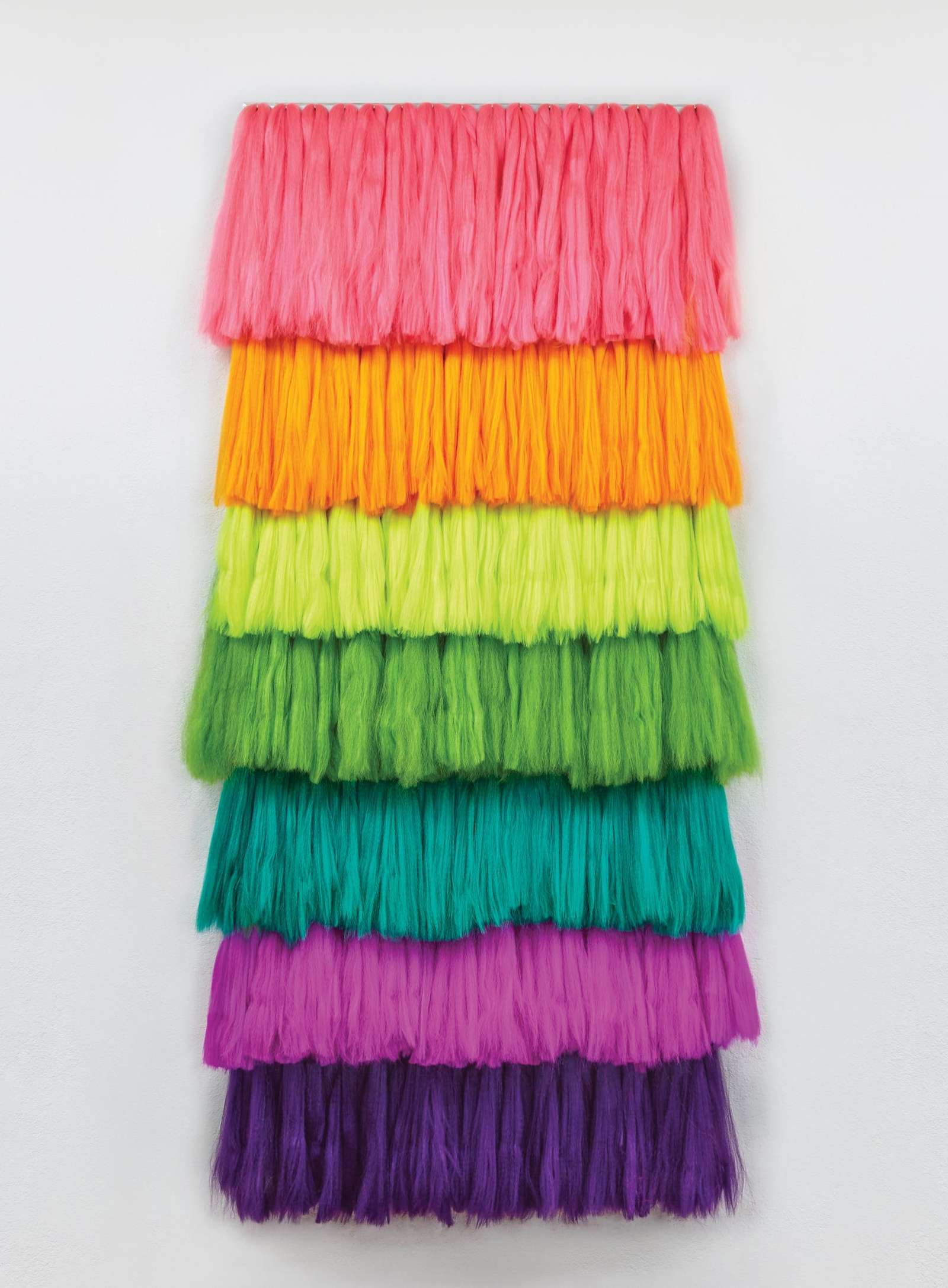 a rainbow fringe tapestry by Lauren Halsey