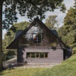 Traditional mountain cottage with steep roofs, stone bases, and timber gables blending authentic design with modern simplicity.