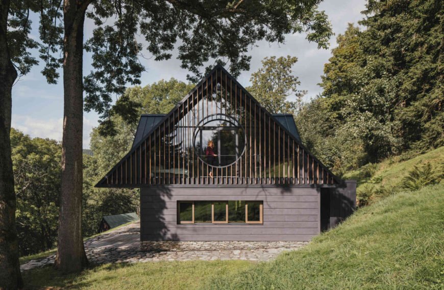 Traditional mountain cottage with steep roofs, stone bases, and timber gables blending authentic design with modern simplicity.