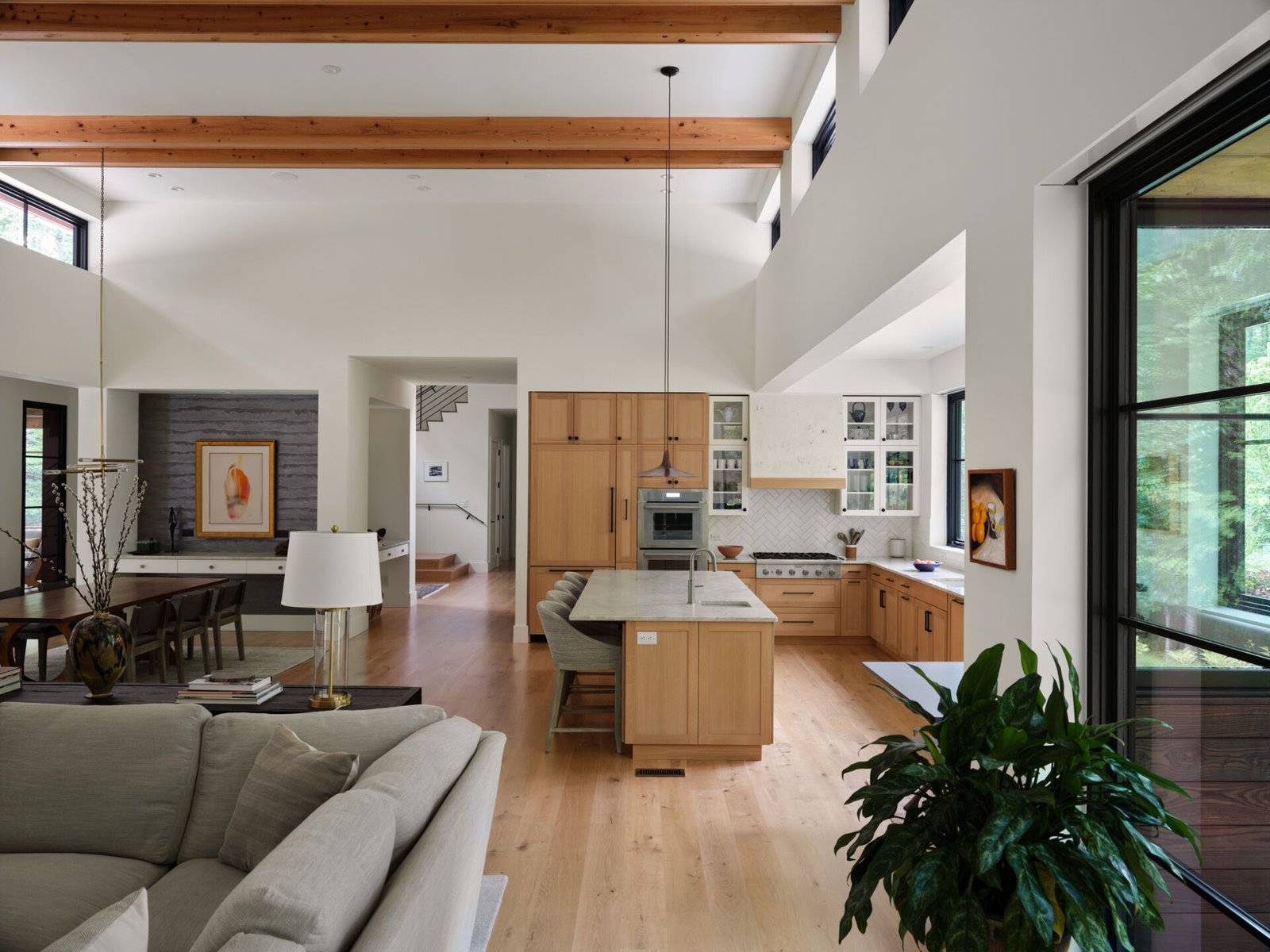 Warm wood finishes and clean lines shape this open kitchen designed for both function and connection.