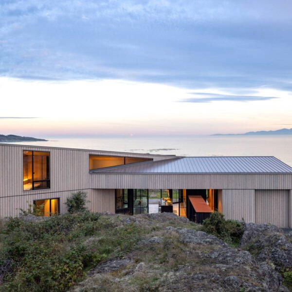 Cedar cladding and weathered finishes allow this home to blend into the rugged coastline.
