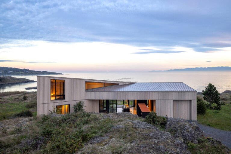 Cedar cladding and weathered finishes allow this home to blend into the rugged coastline.