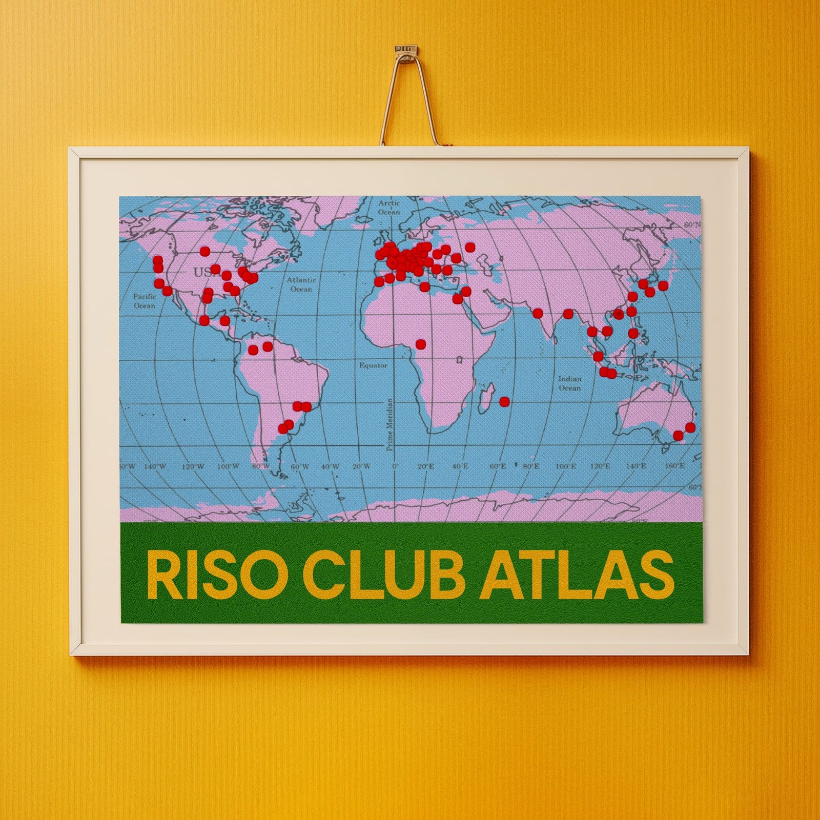 a world map printed and hanging on a yellow wall