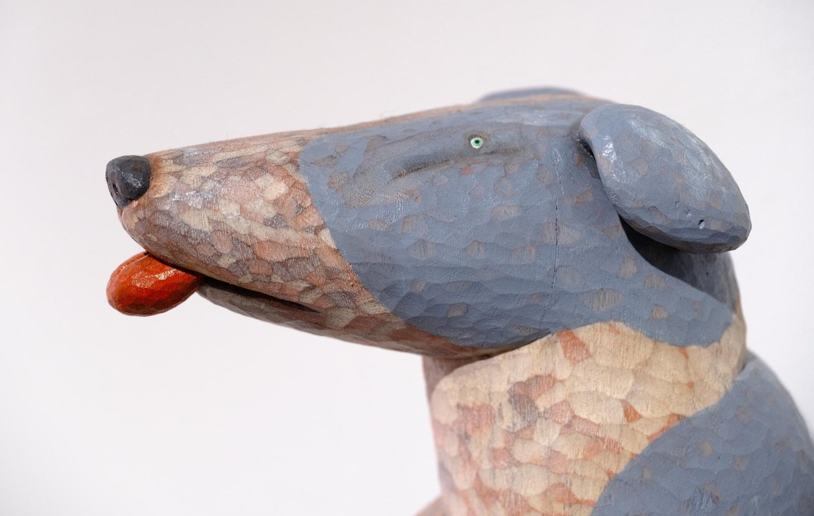 profile detail of a wood-carved whippet sculpture by Misato Sano
