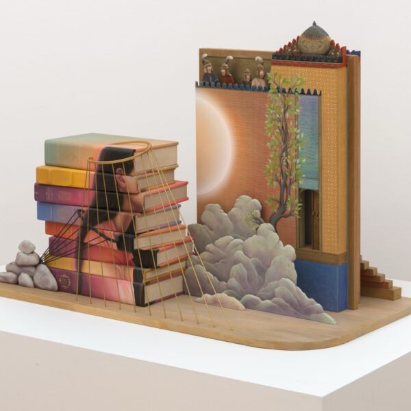 a sculpture with a stack of books, clouds, a building, and a woman's silhouette bound with gold cords