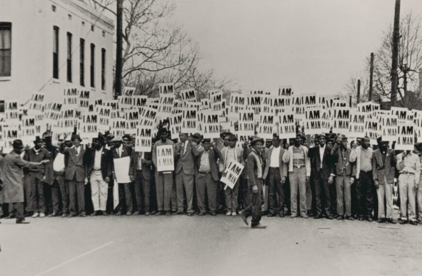 a black and white photo of a crowd picketing