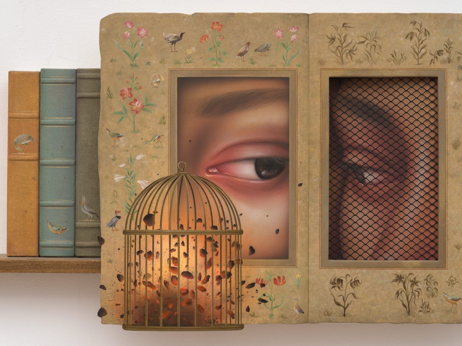 a shelf like sculpture with books, a horse shaped bookend, and a frame with two eyes peering at each other. a bird cage is in front