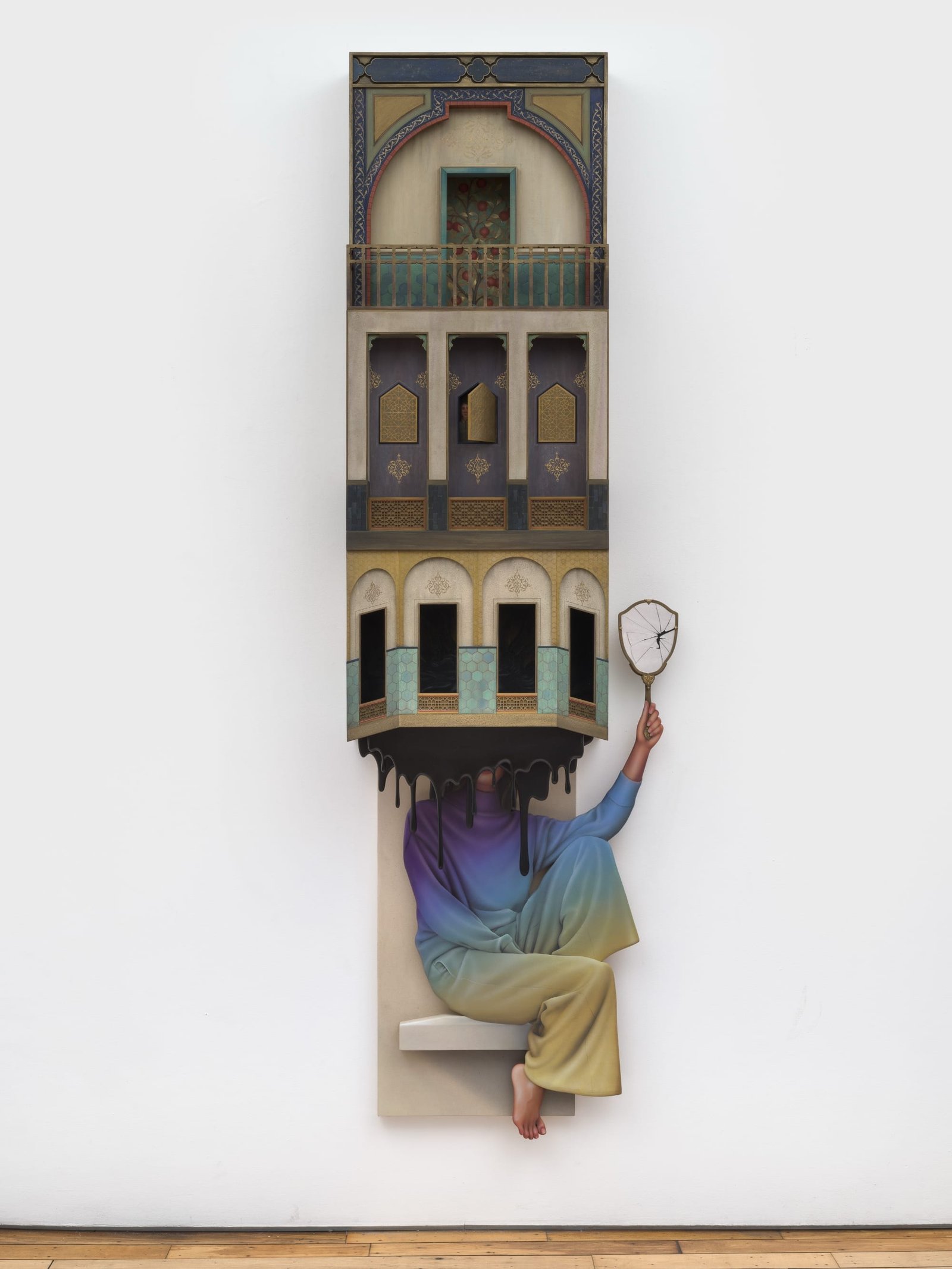 an architectural sculpture of a building dripping black over a woman holding a broken hand mirror
