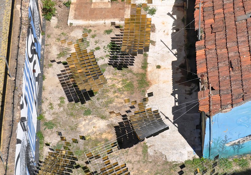kinetic mirrored installation in portugal by moradavaga evokes a shoal of golden fish - 1