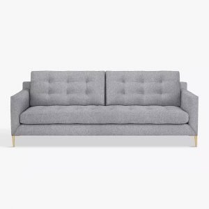 A grey three seater sofa with wooden legs