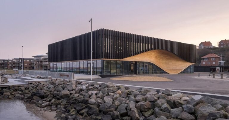 3XN honors denmark’s ship-building heritage with the fluid facade of its ‘klimatorium’