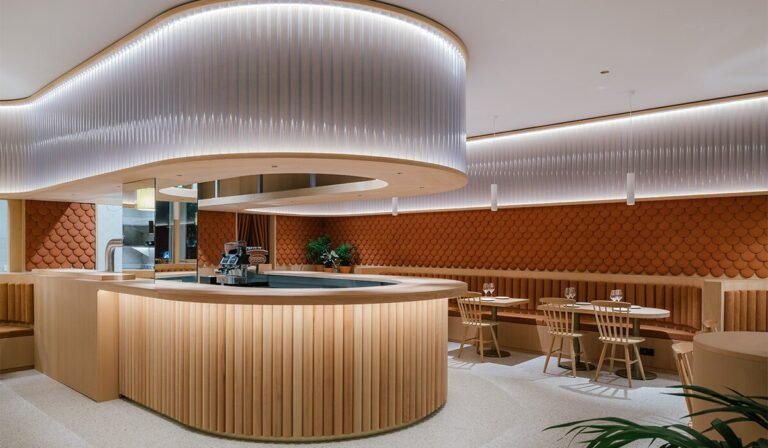 zooco estudio wraps restaurant inside in spain with clay scales and semi-transparent pipes